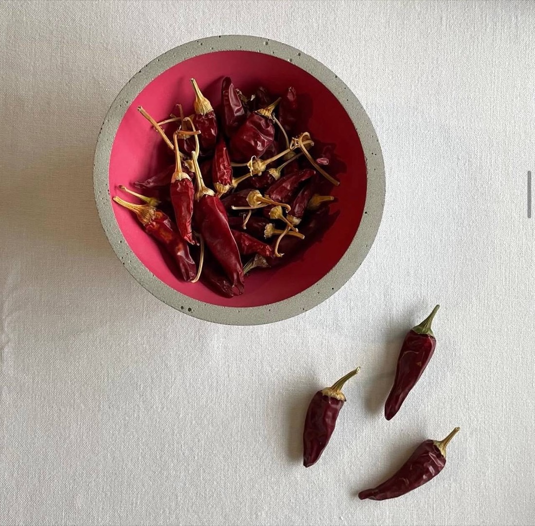Dried red chillies in a magenta concrete bowl