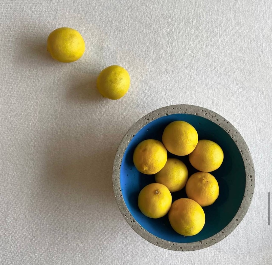 Lemons in a blue concrete bowl